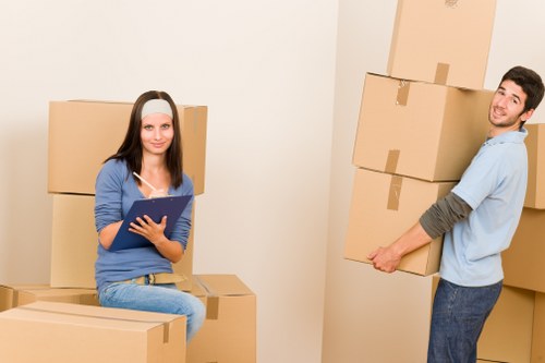Professional movers loading household items carefully for a local North London move