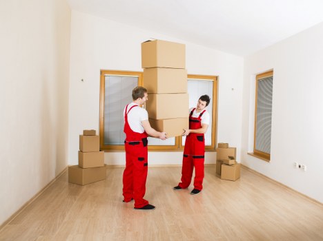Furniture removal crew lifting a bed frame during a Harringay collection